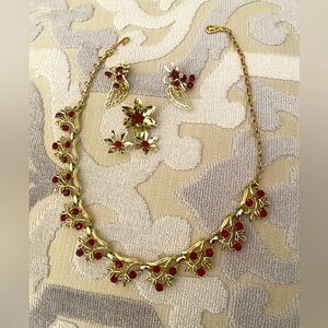 Beautiful vintage custom jewelry: necklace, earrings and brooch with red stones.